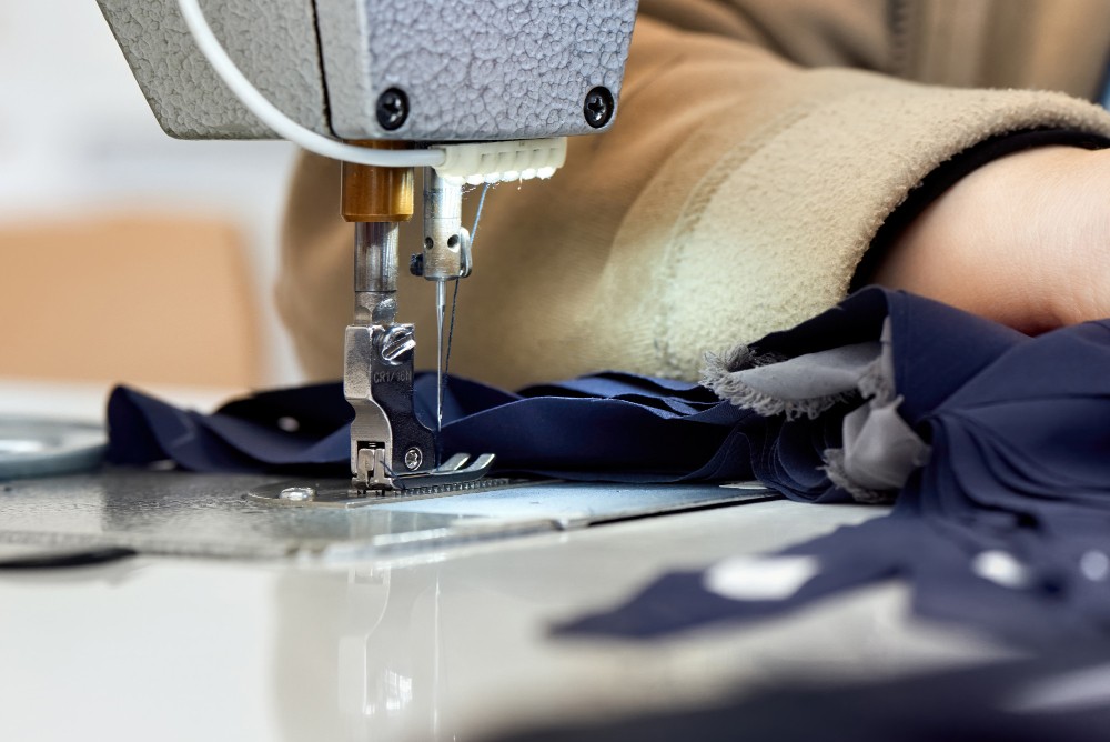 Close-up of a professional seamstress hemming pants.